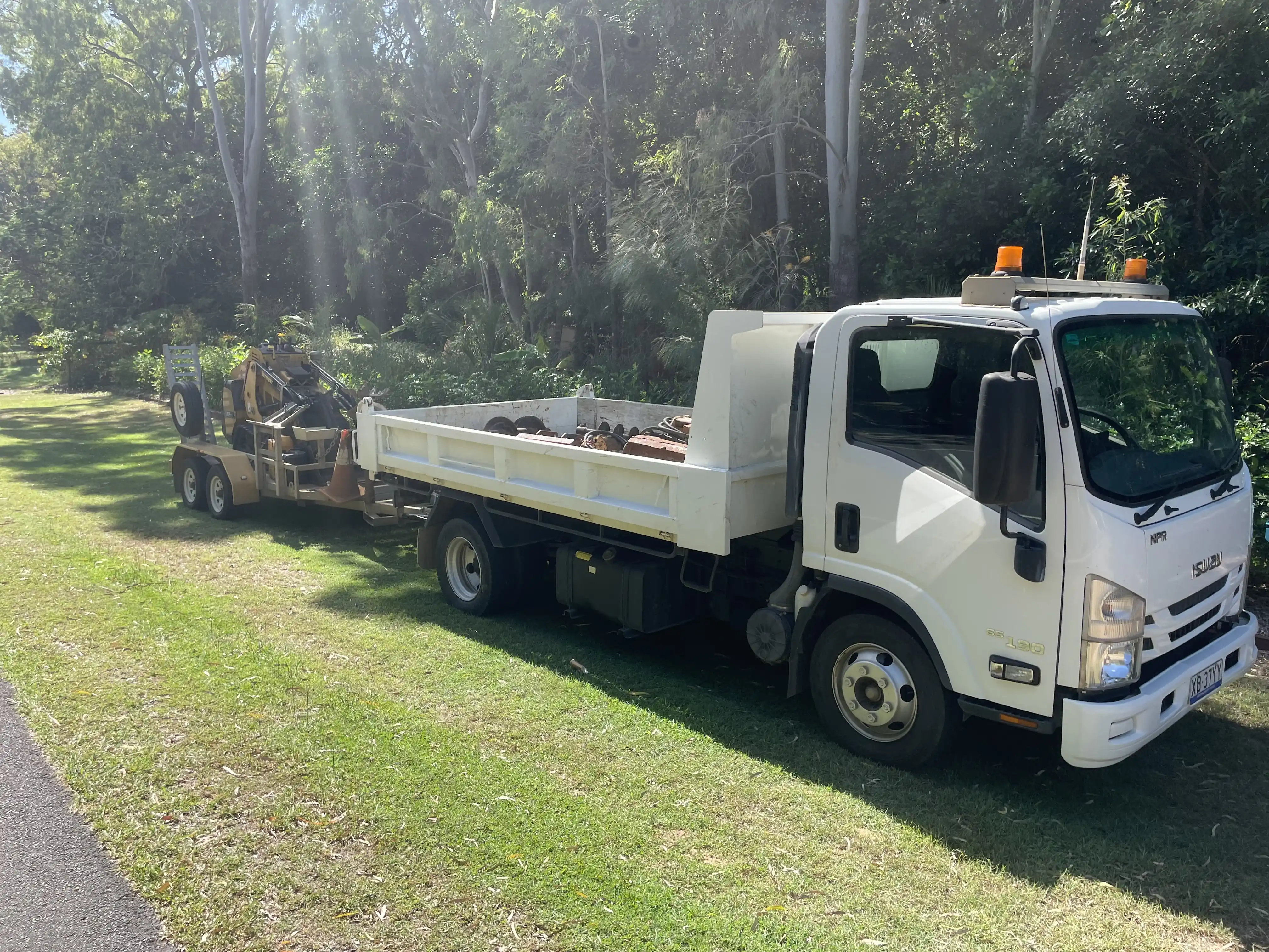 Branded Bundy Dingo mini loader and tipper truck working on a Bundaberg earthworks site