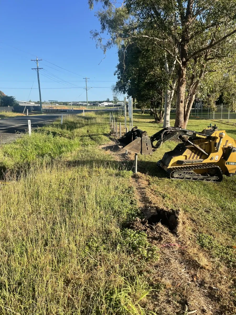 Bundy Dingo mini excavator clearing a stump on a Bundaberg property